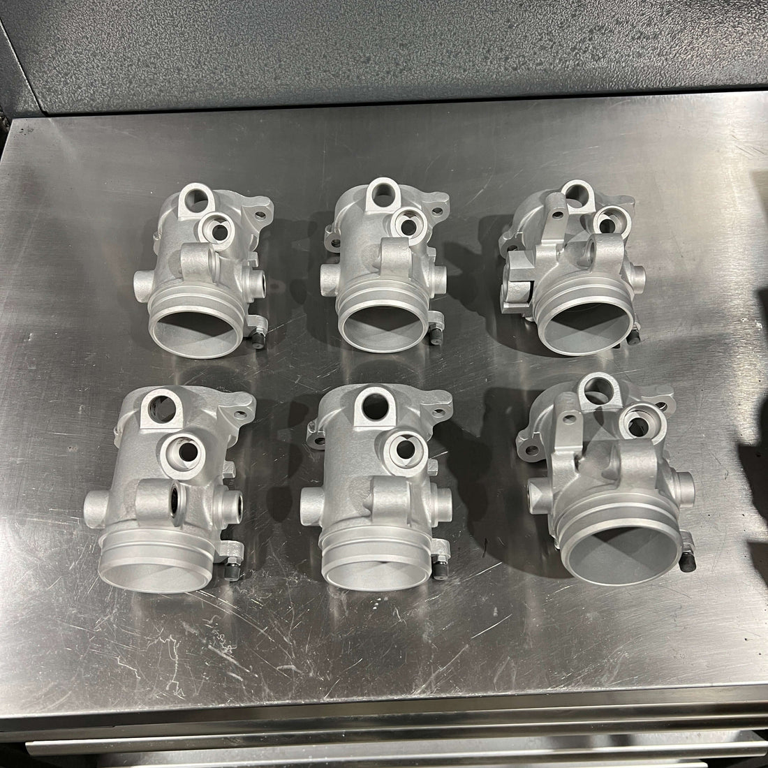 Top Benefits of Vapour Blasting for Automotive Restoration in Lincolnshire - restored engine parts on a workbench.