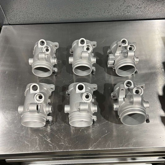 Top Benefits of Vapour Blasting for Automotive Restoration in Lincolnshire - restored engine parts on a workbench.