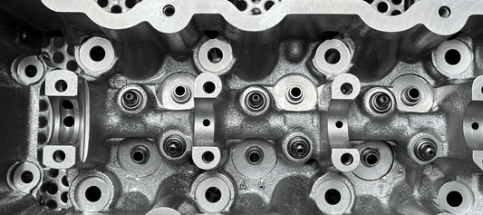 Vapour Blasting process removing contaminants from engine cylinder head for parts restoration.