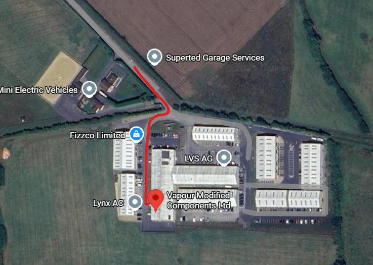 Map showing industrial buildings with labels and a red line indicating a route.